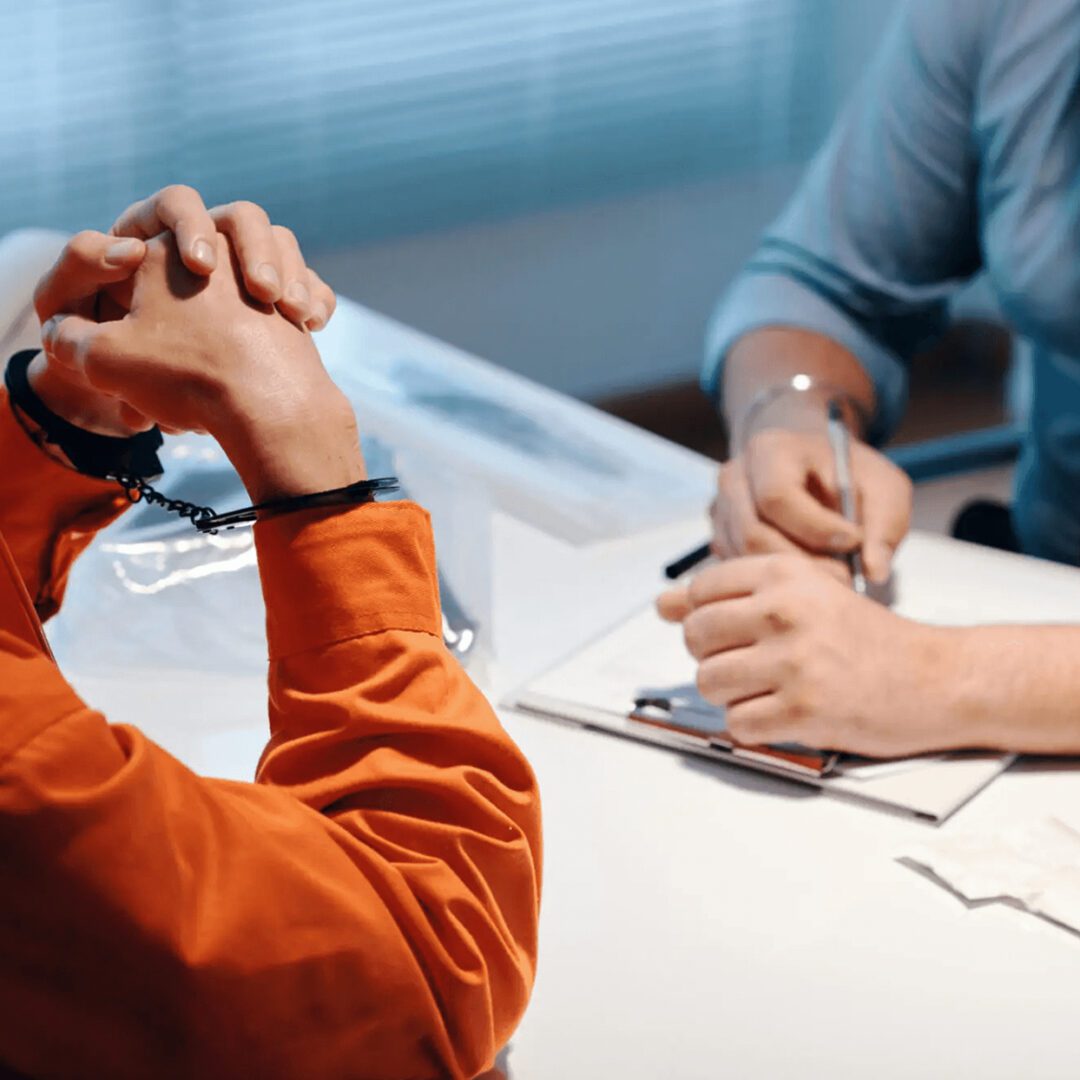 Two people engaged in a serious conversation at a desk.