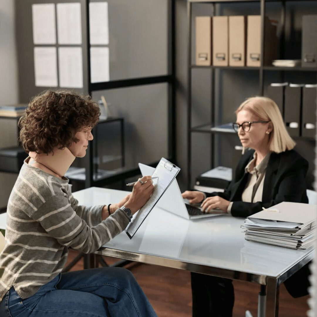 A man and a woman discussing documents in a modern office.