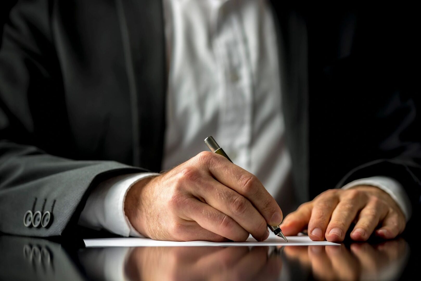 Lawyer signing legal documents with pen