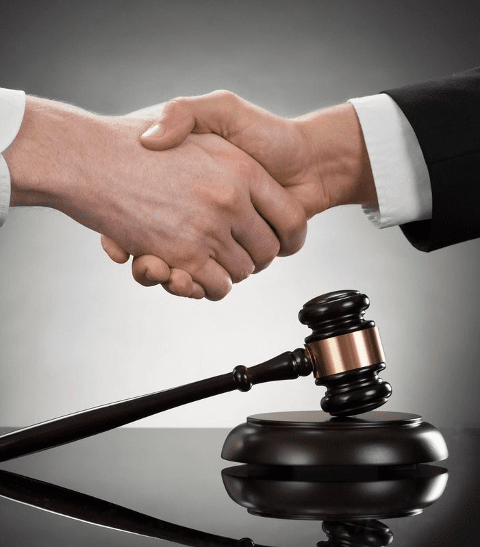 Handshake over gavel, symbolizing legal agreement.