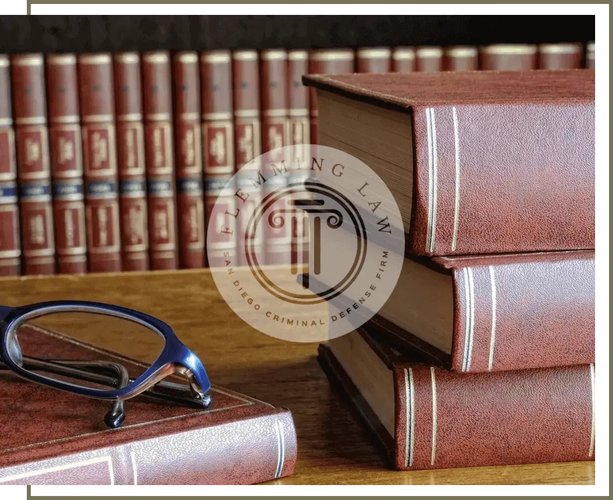 Leather law books and reading glasses on desk